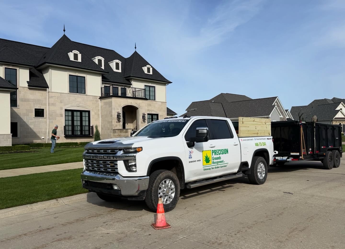 Branded Precision Grounds Chevrolet truck and dump trailer